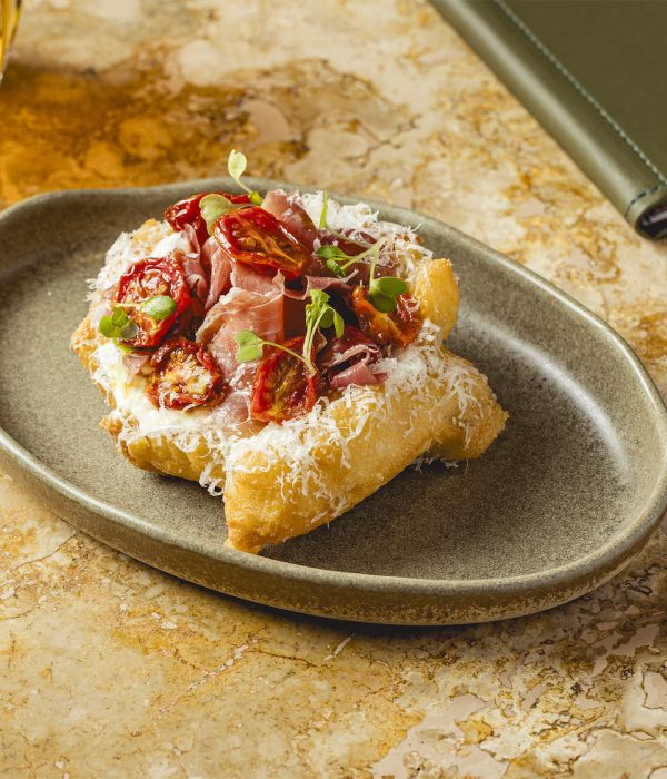 Lángos with sour cream, cheese and aged ham
