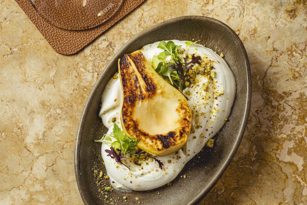 Goat cheese cream with roasted pear, toasted pistachios and toast