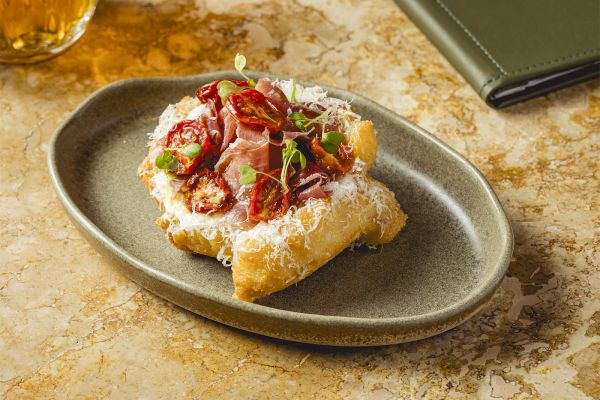 Lángos with sour cream, cheese and aged ham